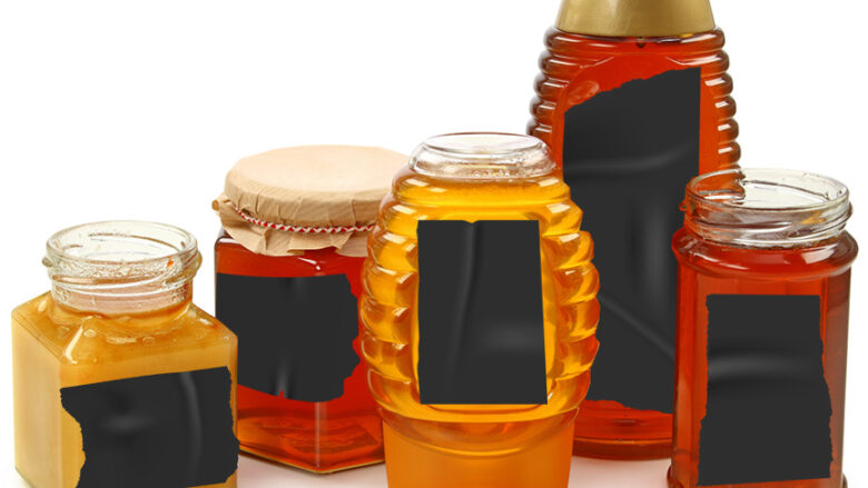 honey jars with labels blacked out with tape